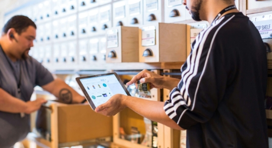Man with tablet surrounded by boxes