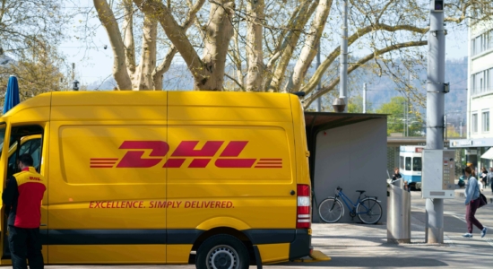 DHL delivery truck parked in the street